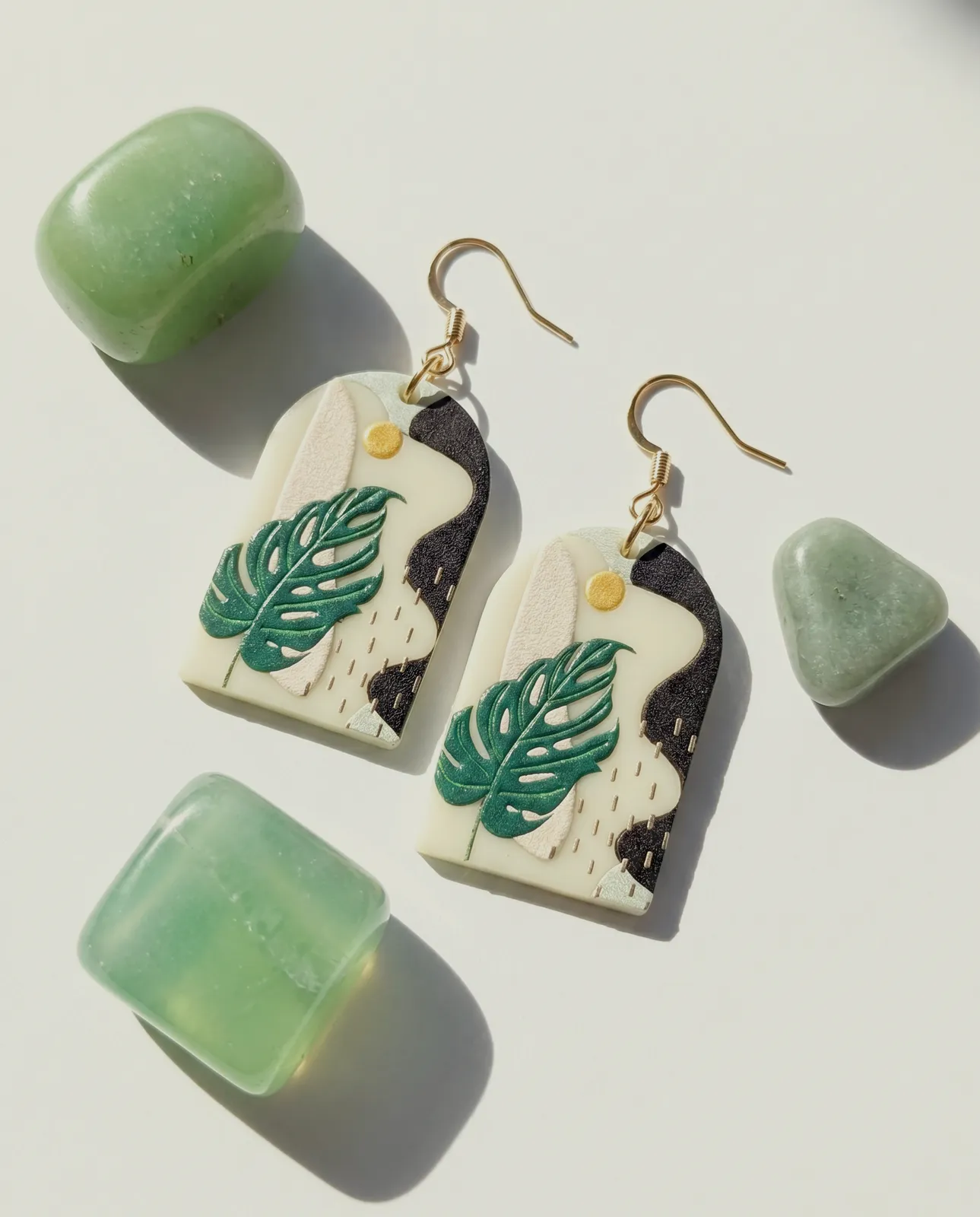 Monstera-leaf earrings styled with jade stones